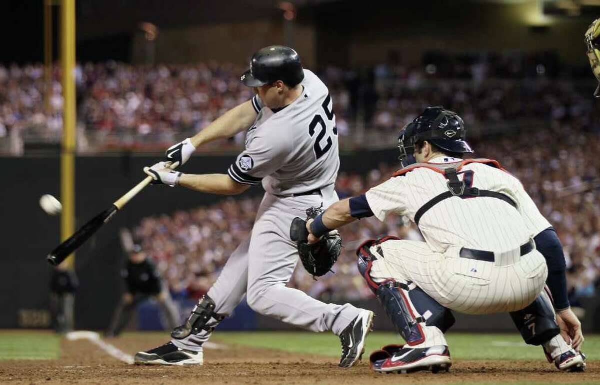 MINNEAPOLIS - OCTOBER 07: Mark Teixeira #25 of the New York Yankees gets a hit as Joe Mauer #7 of the Minnesota Twins catches during game two of the ALDS on October 7, 2010 at Target Field in Minneapolis, Minnesota. (Photo by Elsa/Getty Images) *** Local Caption *** Mark Teixeira