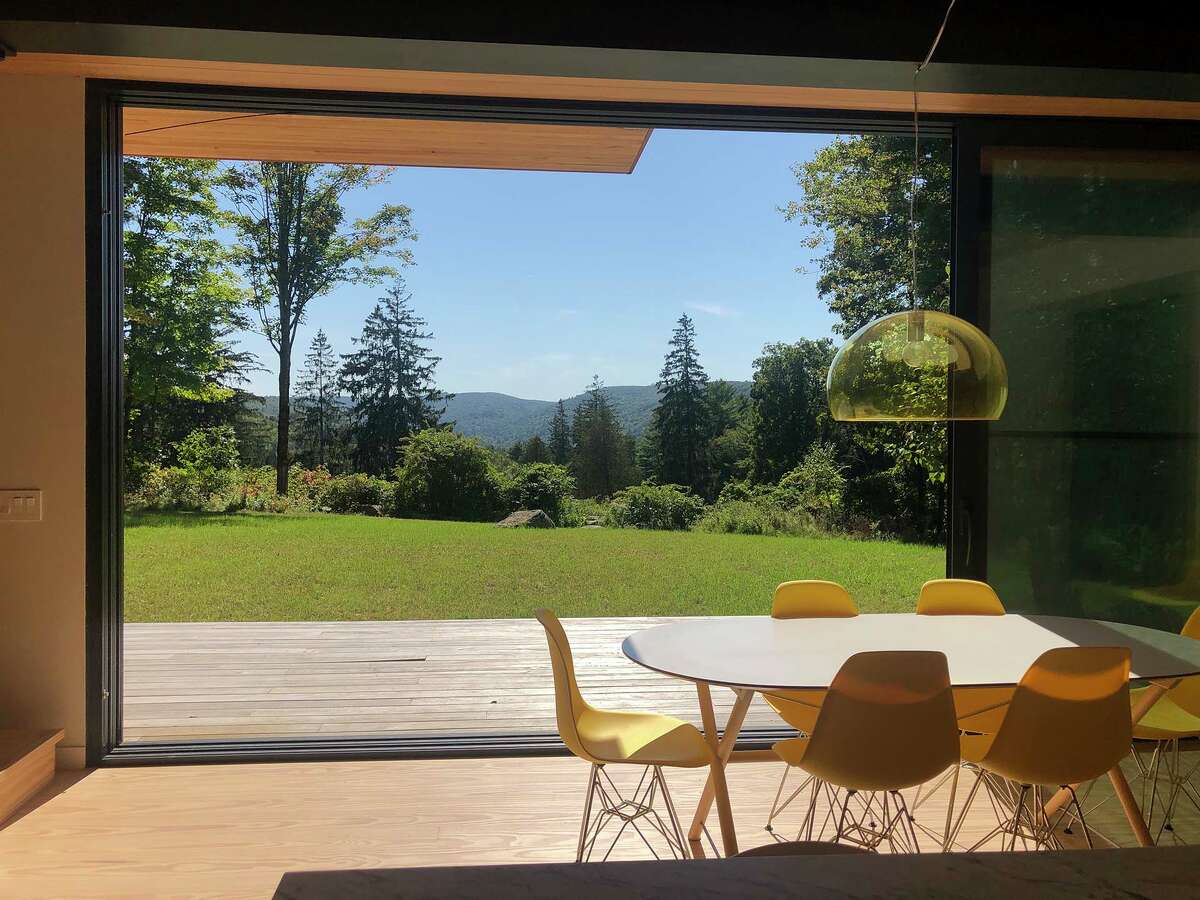 The light, modern kitchen, with large-format windows offerings countryside views, is where the two wings of the structure come together.