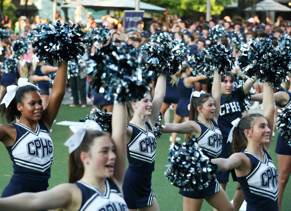 College Park High School cheerleaders perform during the school’s homecoming parade at Market Street, Tuesday, Sept. 21, 2022, in The Woodlands.