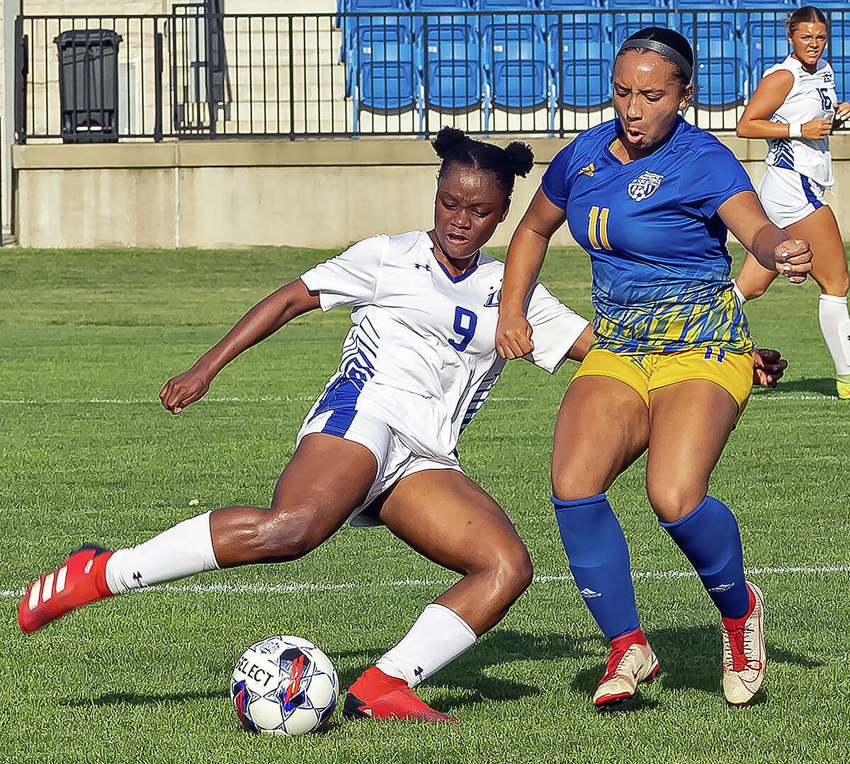 Shaniah Johnson of LCCC (9) and Illinois Central College's Brianna Williams battle for the ball Wednesday.