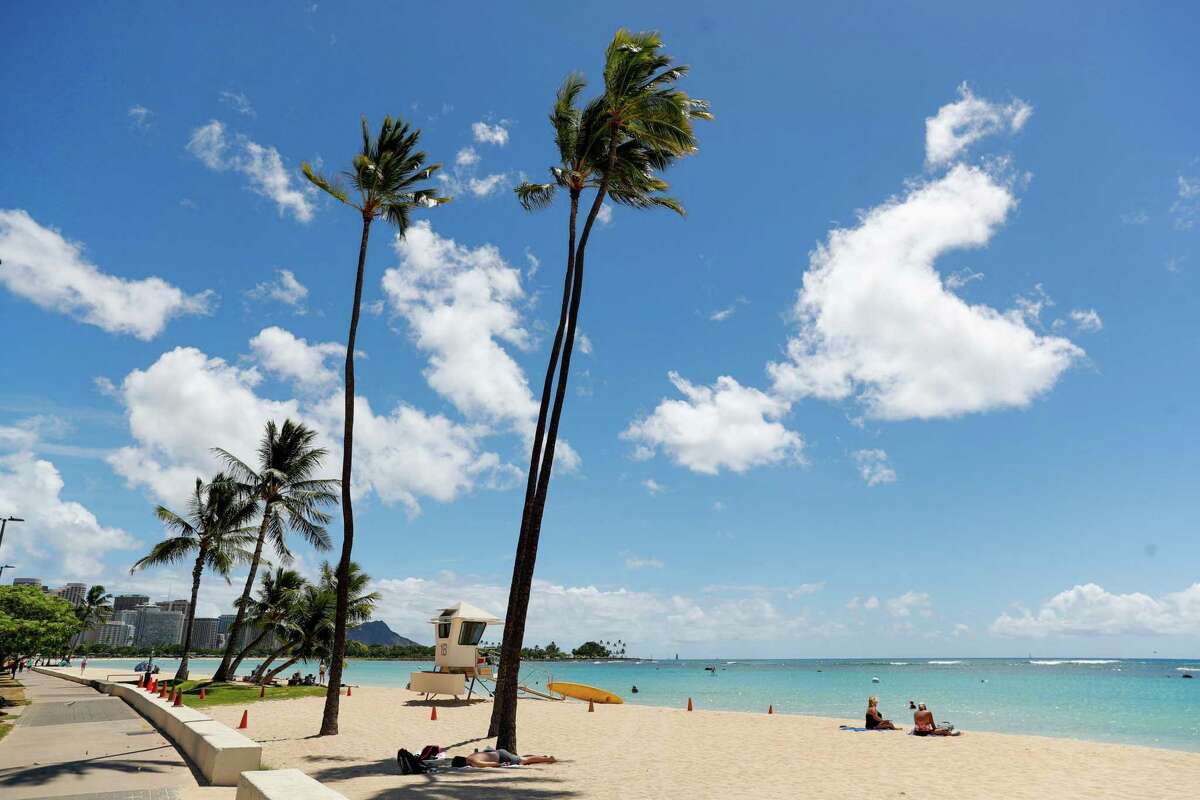 Views like this, at Ala Moana Beach in Honolulu, become common place for remote workers who moved to Hawaii during the pandemic. Many, however, have since left.