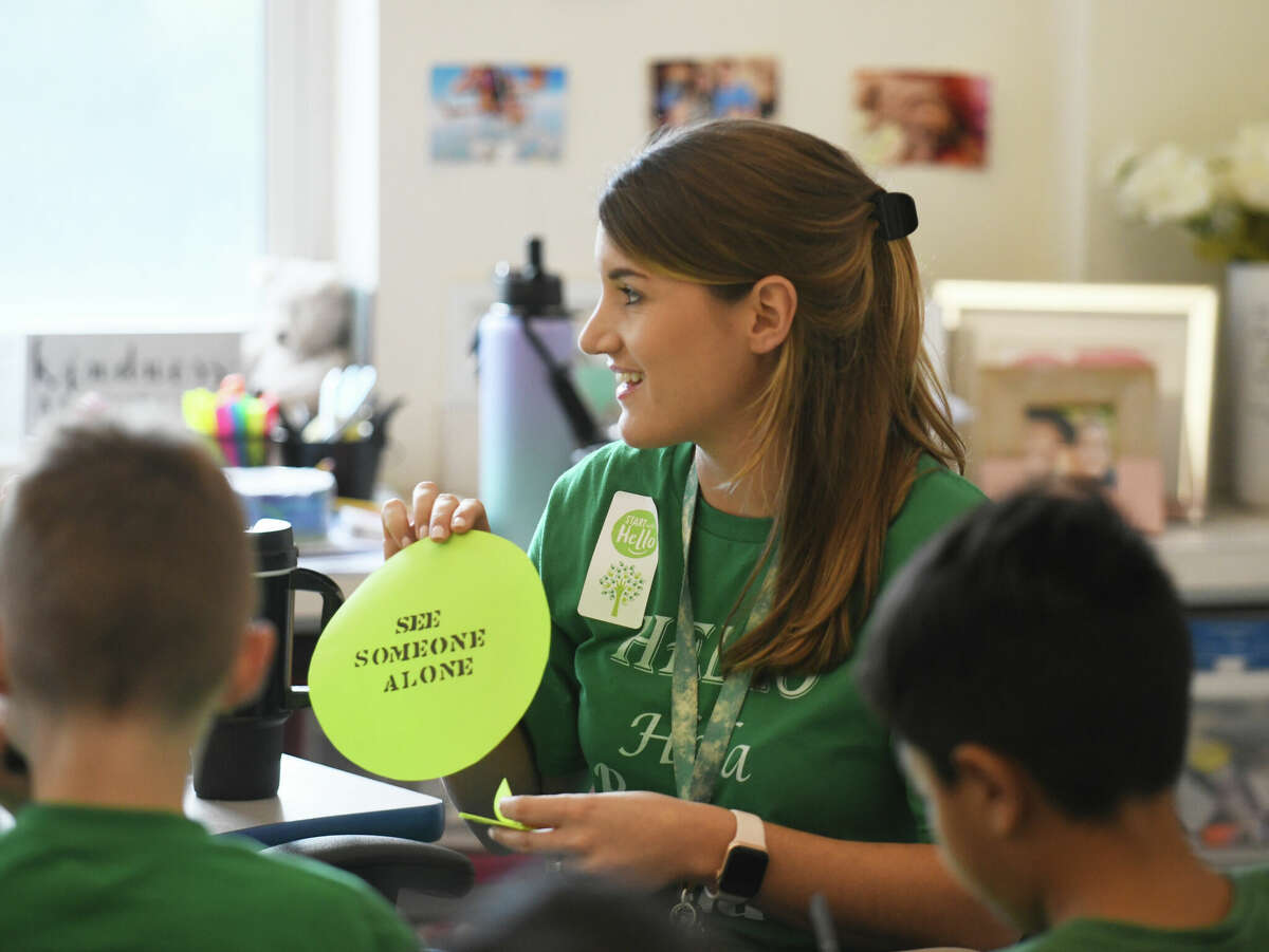Fourth grade teacher and social work intern Cara Pribanic works on an activity with her students for "Wear Green Wednesday" during Start with Hello Week at Hart Magnet Elementary School in Stamford, Conn. Wednesday, Sept. 21, 2022. Hart Elementary celebrated Start with Hello Week along nearly 4,000 schools across the country to teach students actions to "minimize social isolation, empathize with others, and create a more inclusive and connected school culture." The Sandy Hook Promise program encourages students to reach out help students who may feel lonely.