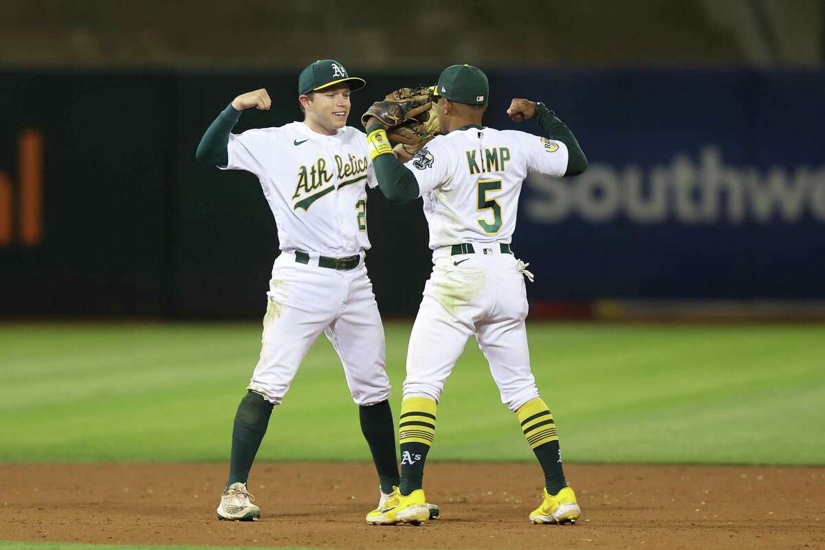 OAKLAND, CALIFORNIA - SEPTEMBER 21: Oakland Athletics infielders Nick Allen #2 and Tony Kemp #5 celebrate after a win against the Seattle Mariners at RingCentral Coliseum on September 21, 2022 in Oakland, California. (Photo by Lachlan Cunningham/Getty Images)