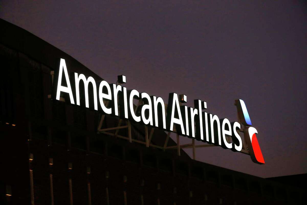 FILE - The American Airlines logo on top of the American Airlines Center in Dallas, Texas on Dec. 19, 2017. Passengers and crew members restrained a passenger who was caught on video slugging a flight attendant on an American Airlines plane. The airline said Wednesday, Sept. 21, 2022, that law enforcement met the plane when it landed in Los Angeles and took the man off the plane.