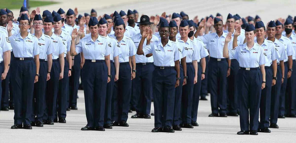 Female airmen are seen taking the oath as the Air Force holds a public graduation ceremony for basic training recruits for the first time in 16 months at JBSA Lackland on Thursday, July 22, 2021. 