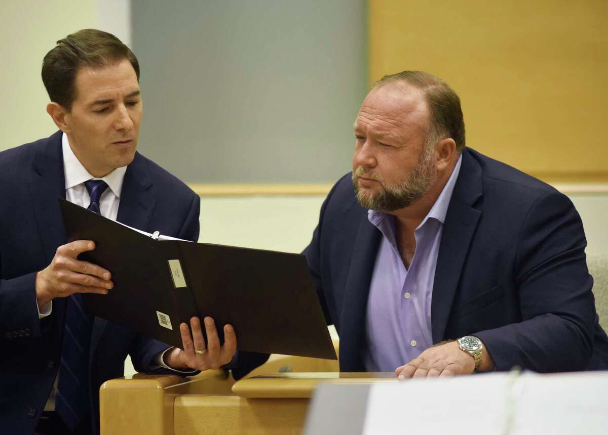 Plaintiff's attorney Chris Mattei, left, questions Conspiracy theorist Alex Jonesduring testimony at the Alex Jones Sandy Hook defamation damages trial at Connecticut Superior Court in Waterbury, Conn. Thursday, Sept. 22, 2022. Jones was found liable last year by default for damages to plaintiffs without a trial, as punishment for what the judge called his repeated failures to turn over documents to their lawyers. The six-member jury is now deciding how much Jones and Free Speech Systems, Infowars’ parent company, should pay the families for defaming them and intentionally inflicting emotional distress. (Tyler Sizemore/Hearst Connecticut Media via AP, Pool)