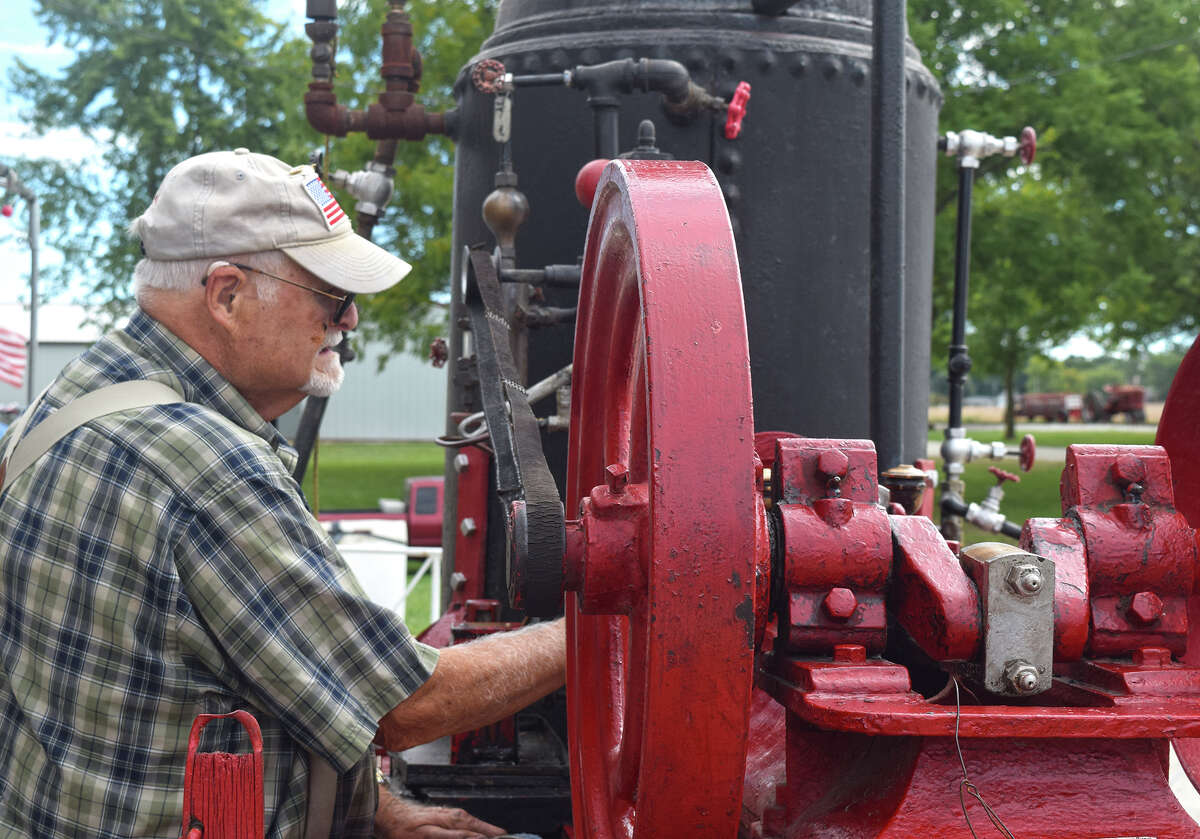 David Chamberlain of Jacksonville cleans a steam engine that powers a kettles to cook ham and beans in preparation for the Prairie Land Heritage Museum Steam Show. The show starts Friday and continues through the weekend.