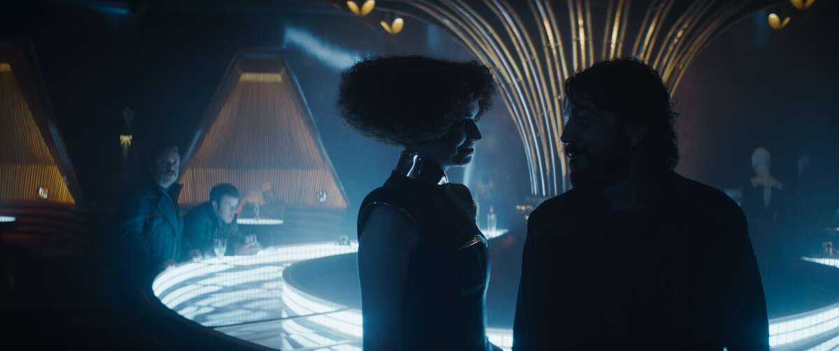 Kravas (Lee Boardman), Verlo (Stephen Wight), hostess (Margaret Clunie), Cassian Andor (Diego Luna) and bartender (Caroline Green) in a scene from "Andor."