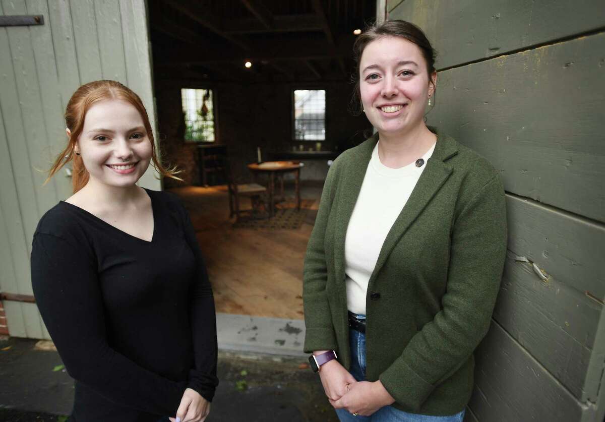 Westport Museum intern Claire Menard, left, and Programs and Collections Director Nicole Carpenter outside the museum's newly renovated cobblestone barn in Westport, Conn. on Thursday, Sept. 22, 2022. The historic barn is being used from Oct. 2 to Oct. 30 as the Connecticut Witch Panic Escape Room. Reservations for the attraction can be made at westporthistory.org.