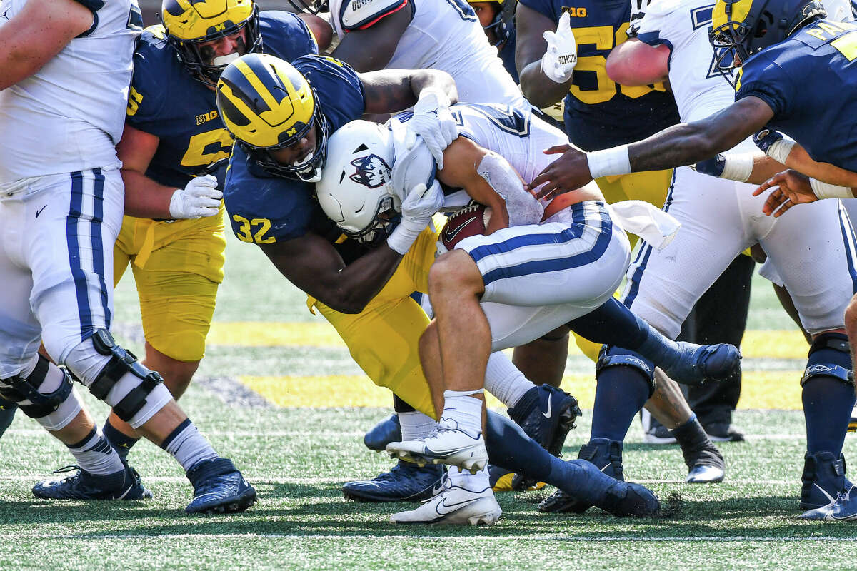 ANN ARBOR, MICHIGAN - SEPTEMBER 17: Jaylen Harrell #32 of the Michigan Wolverine tackles Victor Rosa #22 of the Connecticut Huskies during the second half of a college football game at Michigan Stadium on September 17, 2022 in Ann Arbor, Michigan. The Michigan Wolverines won the game 59-0 over the Connecticut Huskies. (Photo by Aaron J. Thornton/Getty Images)