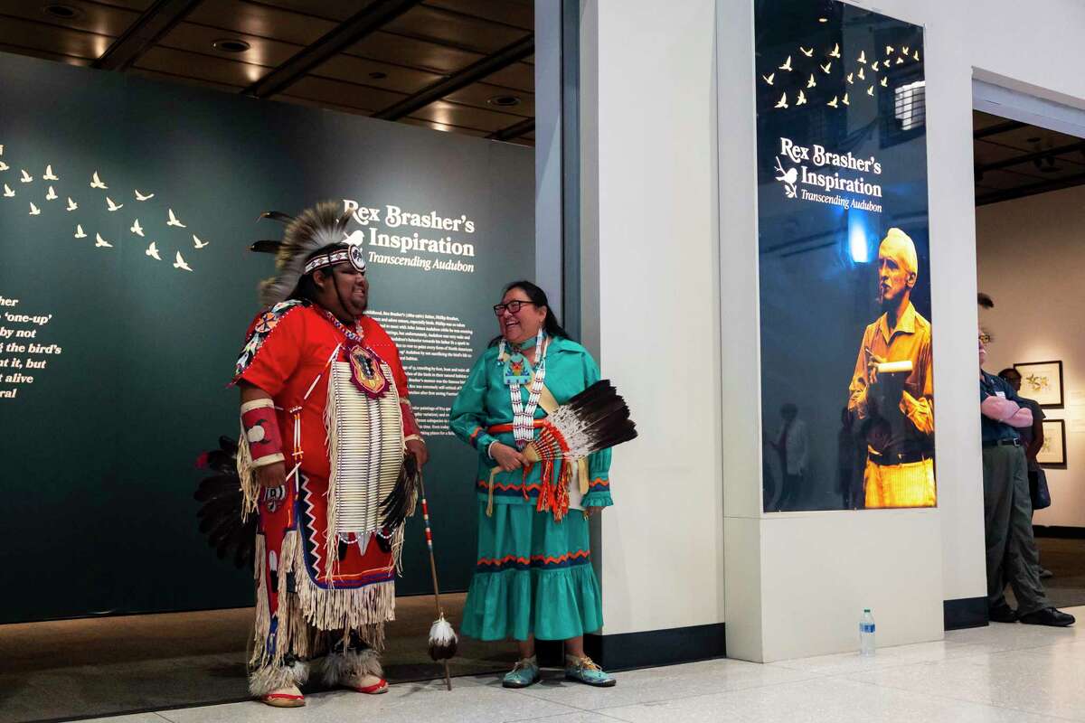 Colby Whitethunder, 24, laughs with Yolanda Poncho between dances at the Houston Museum of Natural Science on Thursday, September 22, 2022. Poncho is the Tribal Council Secretary for the Alabama-Coushatta tribe and danced with fellow members at the museum in honor of the new exhibit honoring the history of people indigenous to Texas.