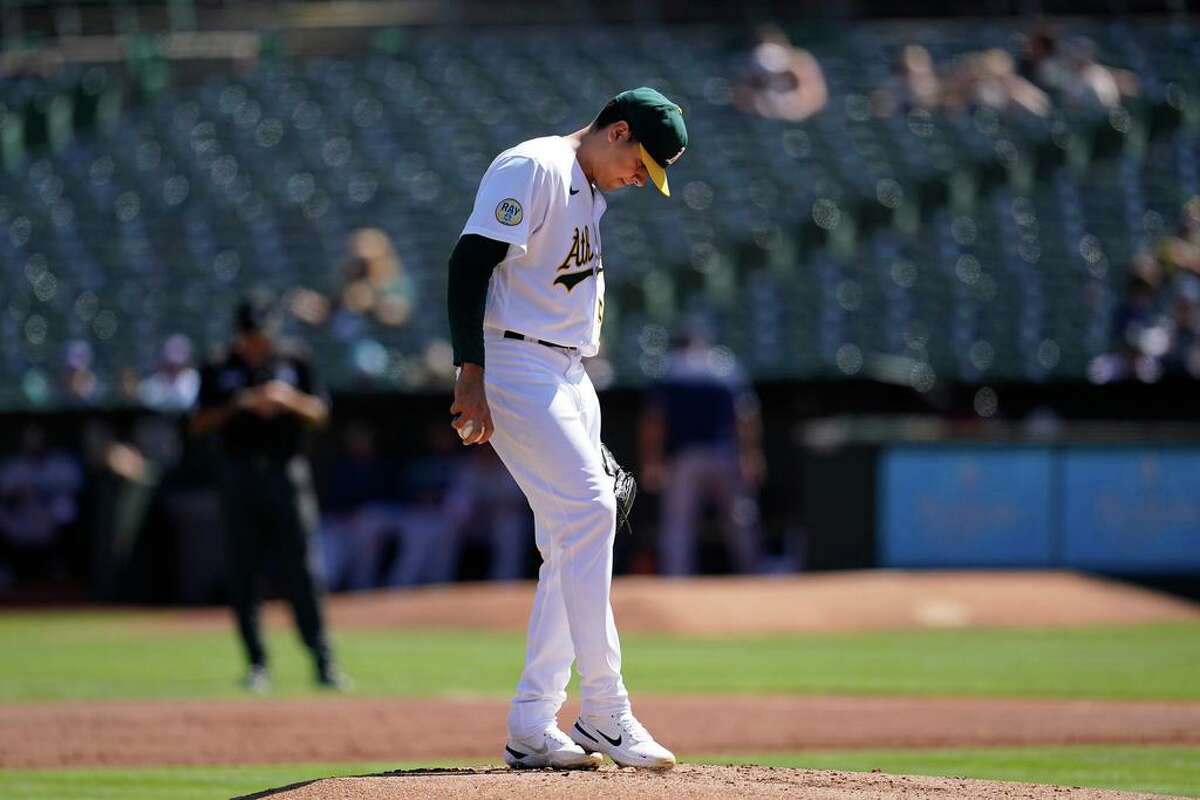 Oakland Athletics pitcher Adrian Martinez reacts after walking Seattle Mariners' Jesse Winker with the bases loaded to score Ty France during the first inning of a baseball game in Oakland, Calif., Thursday, Sept. 22, 2022. (AP Photo/Jeff Chiu)