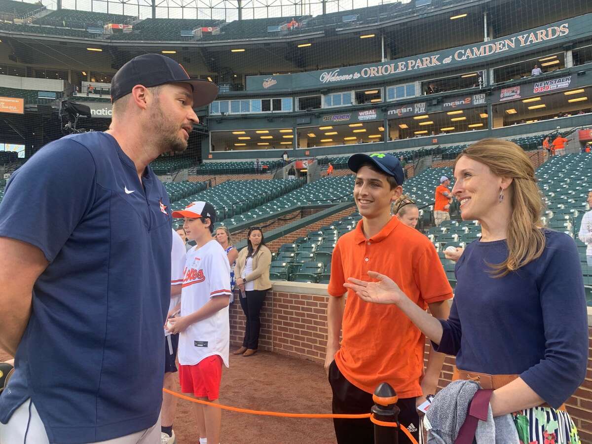 Astros utilityman Trey Mancini chats with Rena Baron and her son Eli before Thursday's game in Baltimore. Mancini's successful return from colon cancer has served as an inspiration for Baron, who was diagnosed with Stage 4 colon cancer in February 2021.