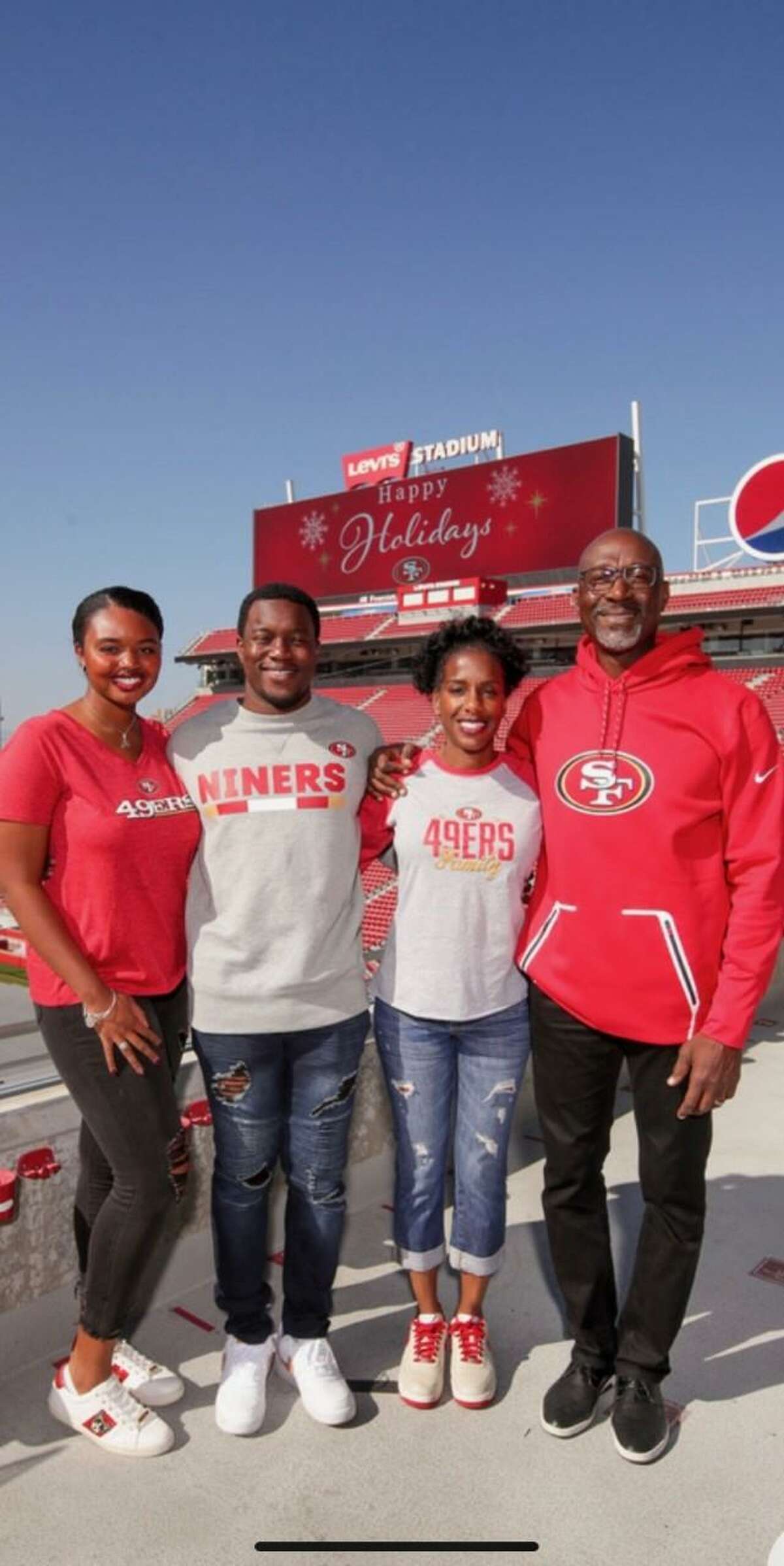 San Francisco 49ers linebackers coach Johnny Holland with his wife, Faither, son, Jordan, and daughter, Joli.