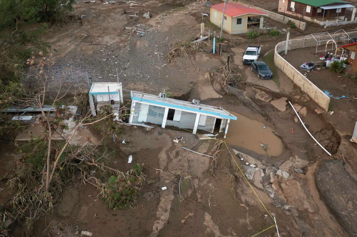 A house lays in the mud after it was washed away by Hurricane Fiona at Villa Esperanza in Salinas, Puerto Rico, Wednesday, Sept. 21, 2022. Fiona left hundreds of people stranded across the island after smashing roads and bridges, with authorities still struggling to reach them four days after the storm smacked the U.S. territory, causing historic flooding.
