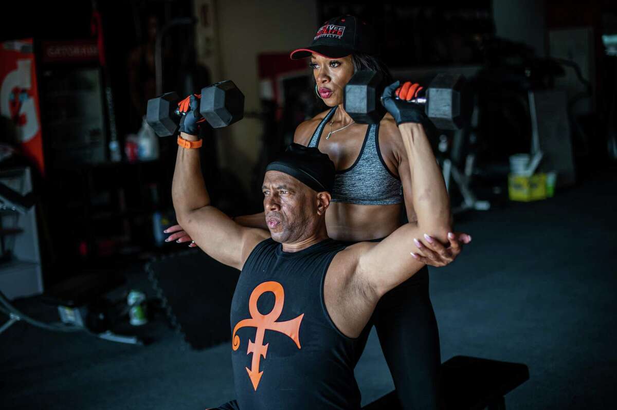 Jennifer Winters (51), coaches Anthony Frazier (55) through dumbbell exercises at Fit 4 Lyfe gym on Thursday, September 22, 2022 in Houston, TX. Mr. Frazier gained weight, as many Americans did, during the Covid-19 pandemic. A year ago, he weighed 230 lbs and began a training program with Ms. Winters to lose weight and become healthier. In the year since they have been working together, Mr. Frazier has lost nearly 50 lbs, weighing in now at 183 lbs. “He’s the best,” said Ms. Winters. “He comes in, he gets his work done. I have to push him a little further than where he needs to go sometimes, but he always comes in to get the job done.” (Meridith Kohut / For the Houston Chronicle)