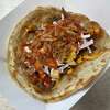 The Turban taco at Twisted Turban contains brisket, cabbage slaw, mango salsa and a spicy sauce on flatbread instead of a tortilla.