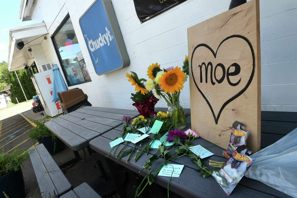 A memorial of flowers and mementos for Mohammad "Moe" Kareem Halabi at the Mobil gas station owned by his parents on the Boston Post Road in Guilford.
