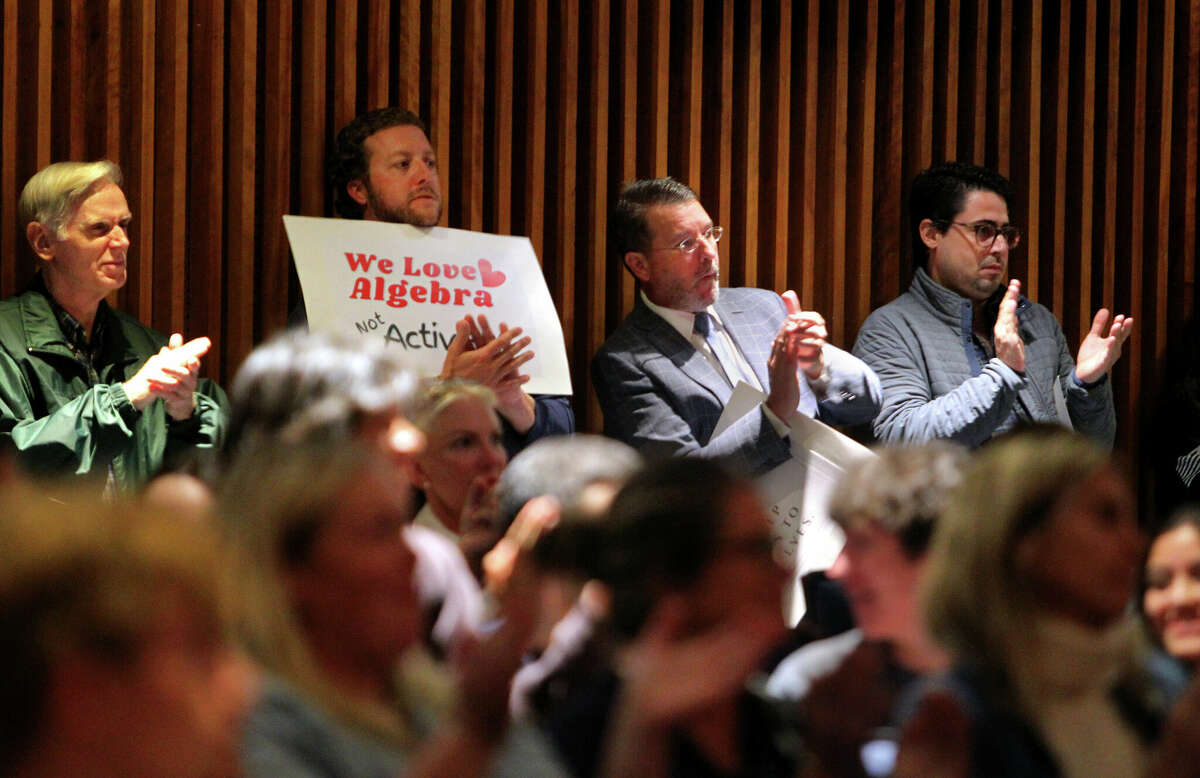 Members of the Greenwich Patriots applaud a speaker during public comments at the Board of Education meeting at Central Middle School in Greenwich, Connecticut on Thursday, September 22, 2022. 