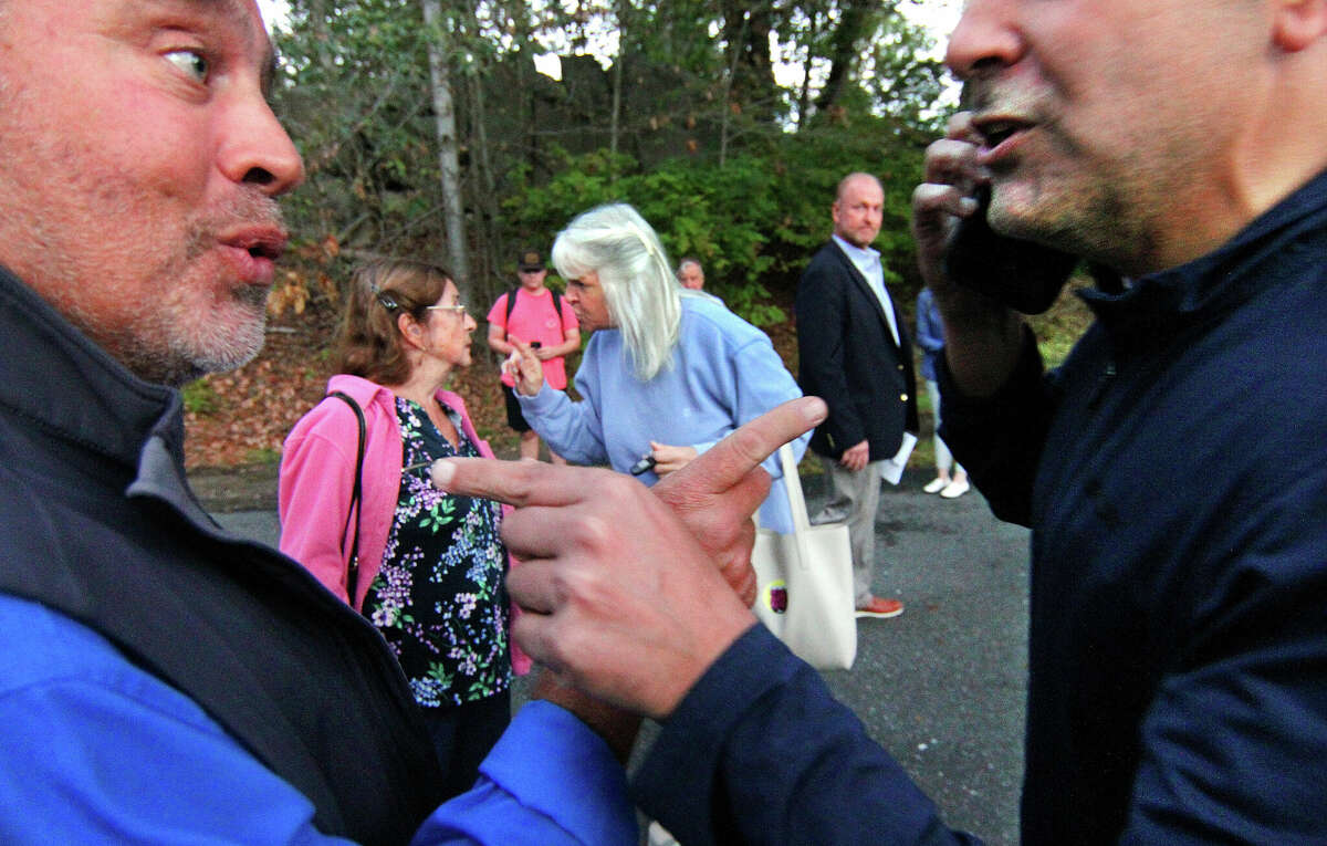 Protesters argue and point fingers at each other before a Board of Education meeting at Central Middle School in Greenwich, Conn., on Thursday September 22, 2022. 