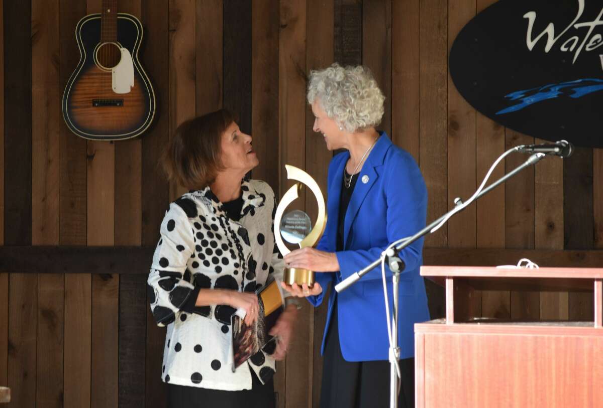 Illinois College President Barbara Farley (right) accepts the 2021 Harold Cox Industry of the Year award from Jacksonville Regional Economic Development Corp. officer Ginny Fanning.