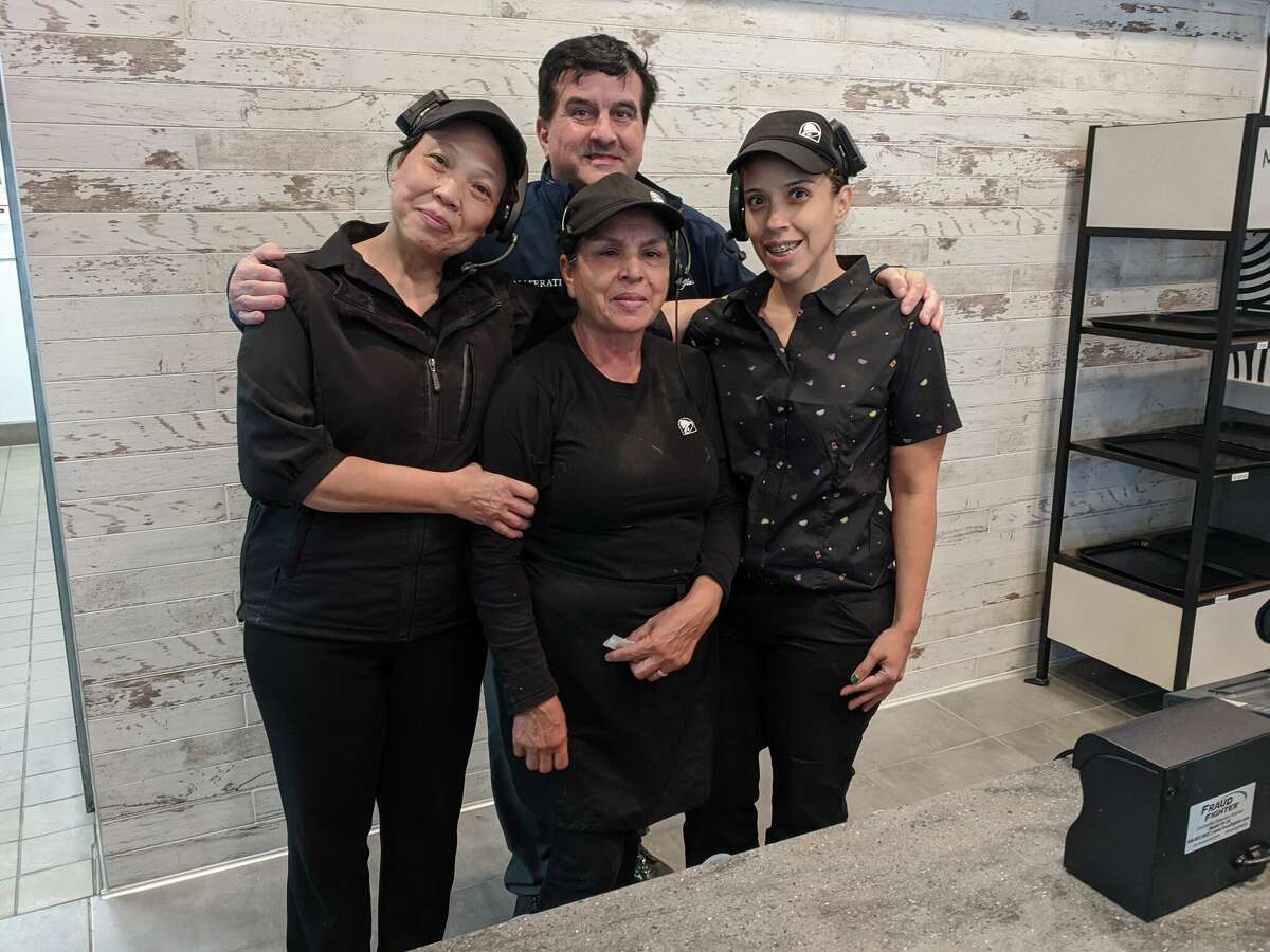 Taco Bell employees, from left, Oanh Nguyen, Brianca Garcia and Jessica Aguirre joined manager Tom Sorge and Taco Bell representatives from three states for Friday's grand reopening celebration of the renovated restaurant.