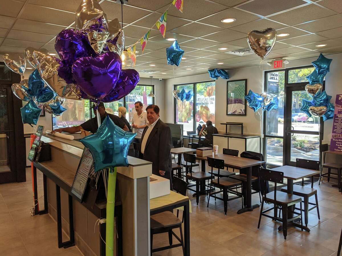 The final touches are put in place including balloons and cake for the grand reopening of the Riverside Taco Bell.