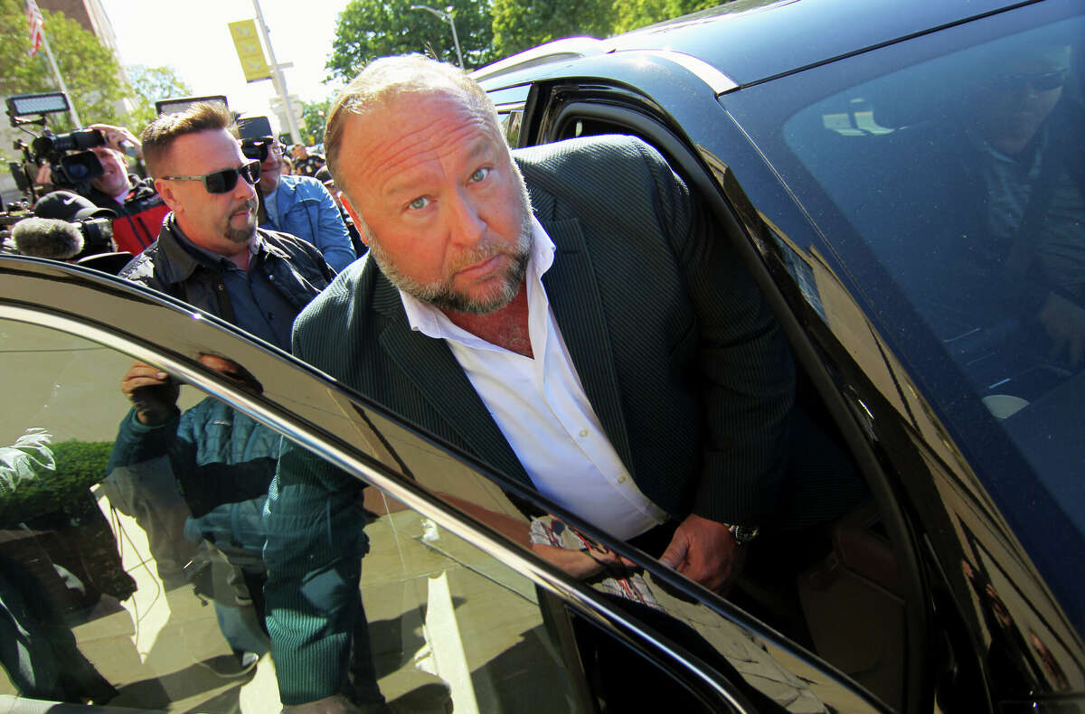 Infowars host Alex Jones leaves after speaking to the media outside Connecticut Superior Court during the ongoing Sandy Hook defamation damages trial in Waterbury, Conn. Friday, Sept. 23, 2022.