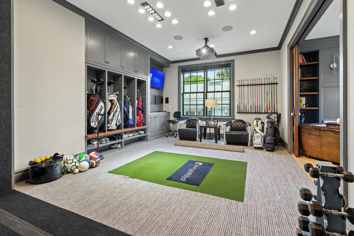 Unit 17 at The Residences at 66 High Street in Guilford, Conn. won two Home Builder Industry (HOBI) Awards and features a golf simulator room.