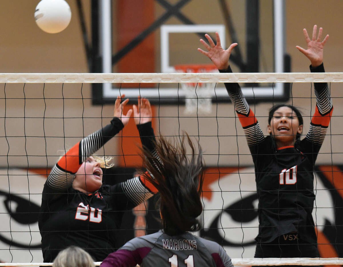 Edwardsville's Claire Dunivan, left, and Ciara Cunningham go up for a block against Belleville West on Thursday inside Lucco-Jackson Gymnasium.