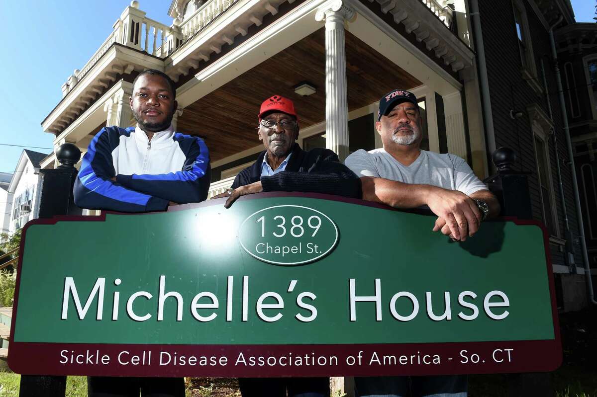 From left, New Haven Fire Department Lt. Samod Rankins, James Rawlings, president and CEO of Sickle Cell Disease Association of America, Connecticut, and retired New Haven Fire Department Capt. Gary Tinney are photographed in front of Michelle's House on Chapel Street in New Haven on September 23, 2022.