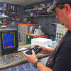 Chad Nelson, owner of Press Start: Games and Videos, plays a game of "Mine Storm" on the Vectrex, a 1980s video game console that is the rarest item in the store.