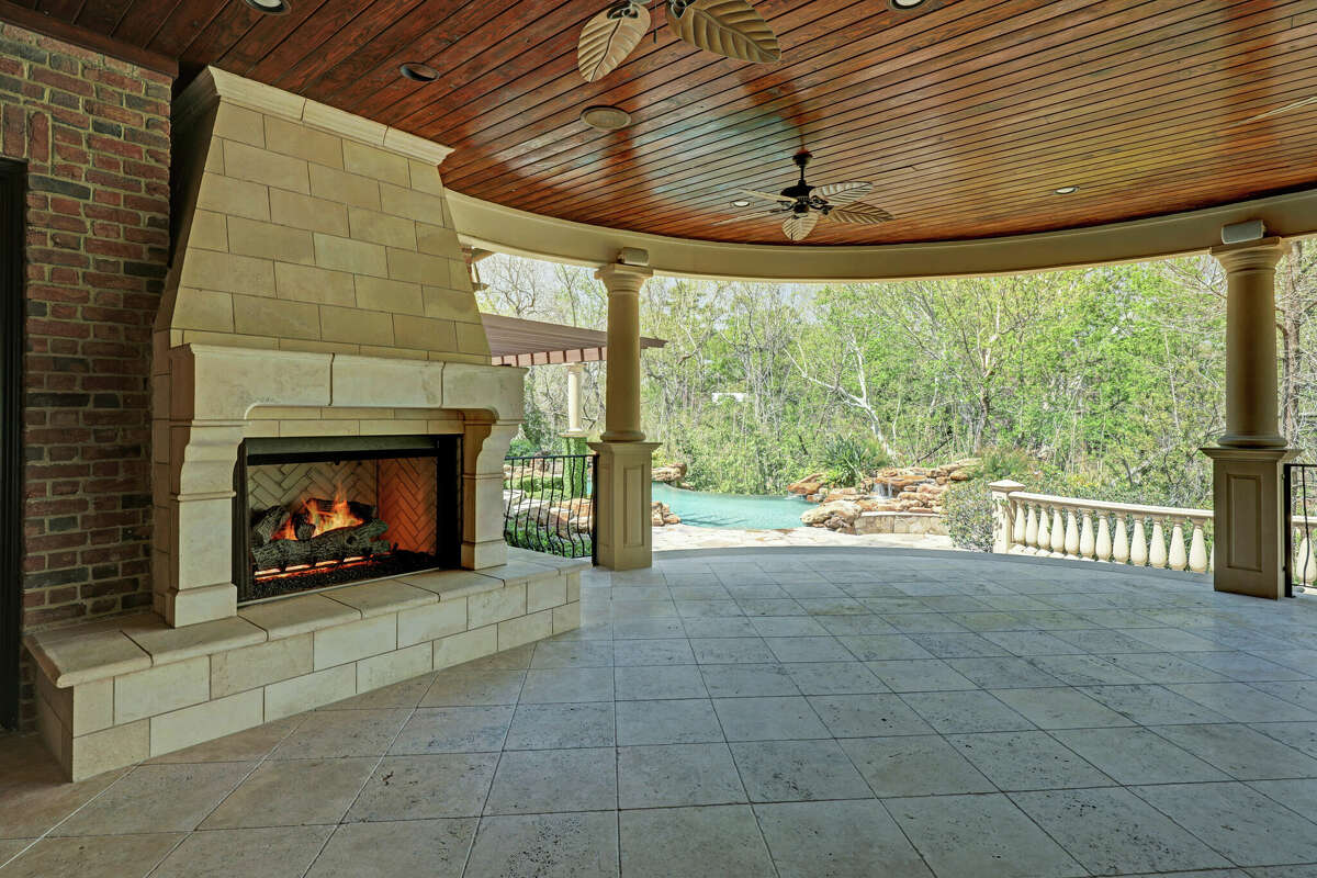 An outdoor fireplace is located on the covered porch