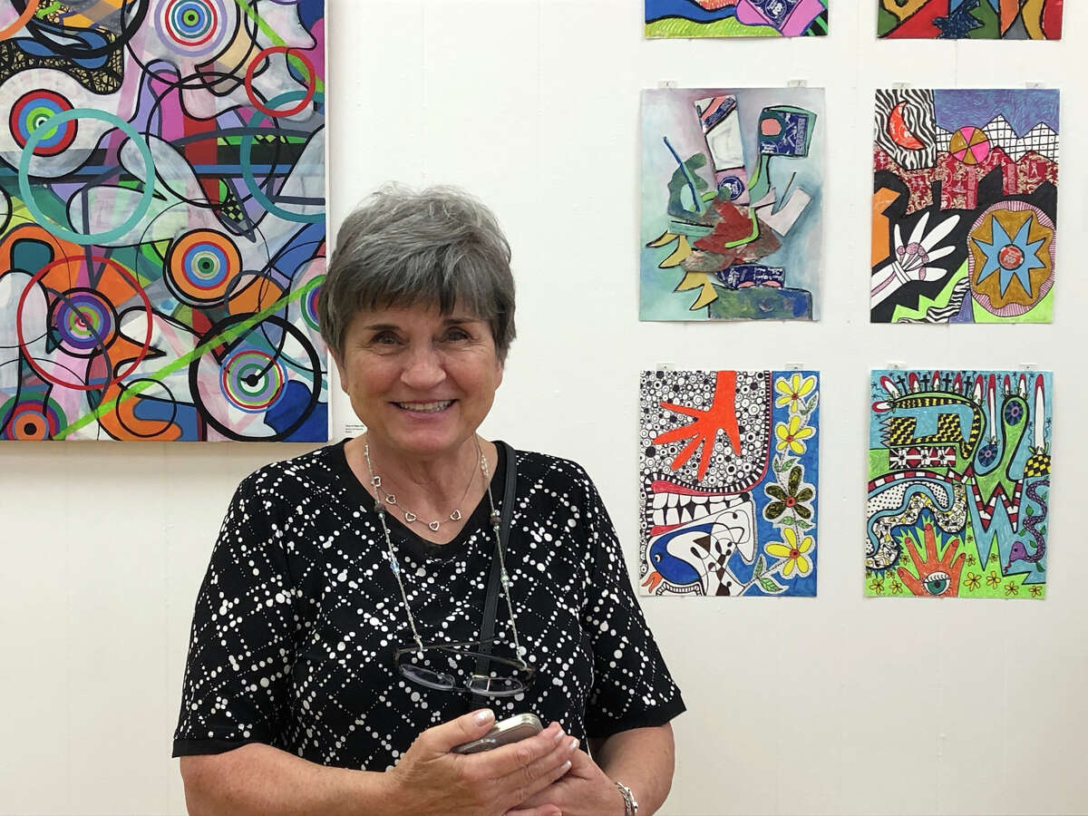 Artist Lina Morielli poses with at the recent opening reception for her art show called "Time in Place" at the Greenwich Art Society. It will be on view through Sept. 30.