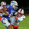 Saratoga quarterback Rodell Evans III picks up yardage in front of Guilderland defender Troy Berschwinger during a game at Saratoga High School on Friday, Sept. 23, 2022. (Jim Franco/Special to the Times Union)