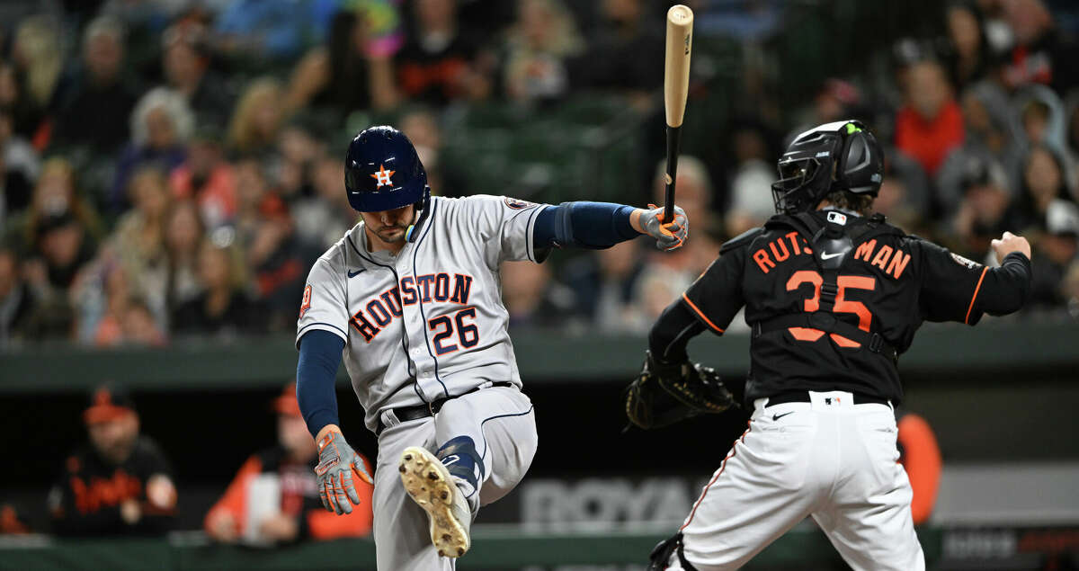 Houston Astros' Trey Mancini strikes out swinging against the Baltimore Orioles during the fifth inning of a baseball game Friday, Sept. 23, 2022, in Baltimore. At right is catcher Adley Rutschman. (AP Photo/Gail Burton)