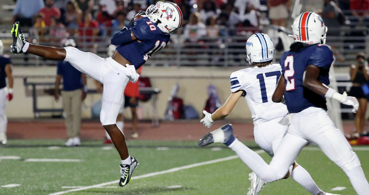 Atascocita defensive back Deion Campbell (10) intercepts the pass intended for Kingwood wide receiver Stone Singletary (17) as Kameron Phoenix (2) follows during the first half of their District 21-6A high school football game Friday, Sept. 23, 2022 in Humble, TX.