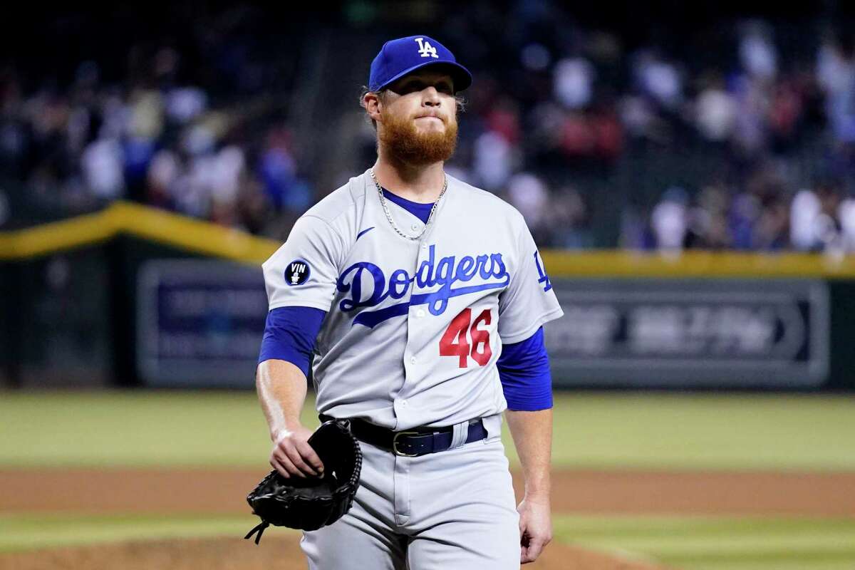 Los Angeles Dodgers relief pitcher Craig Kimbrel walks off the field after giving up a game-ending, three-run home run to Arizona Diamondbacks' Sergio Alcantara during the 10th inning of a baseball game in Phoenix, Wednesday, Sept. 14, 2022. The Diamondbacks won 5-3. (AP Photo/Ross D. Franklin)
