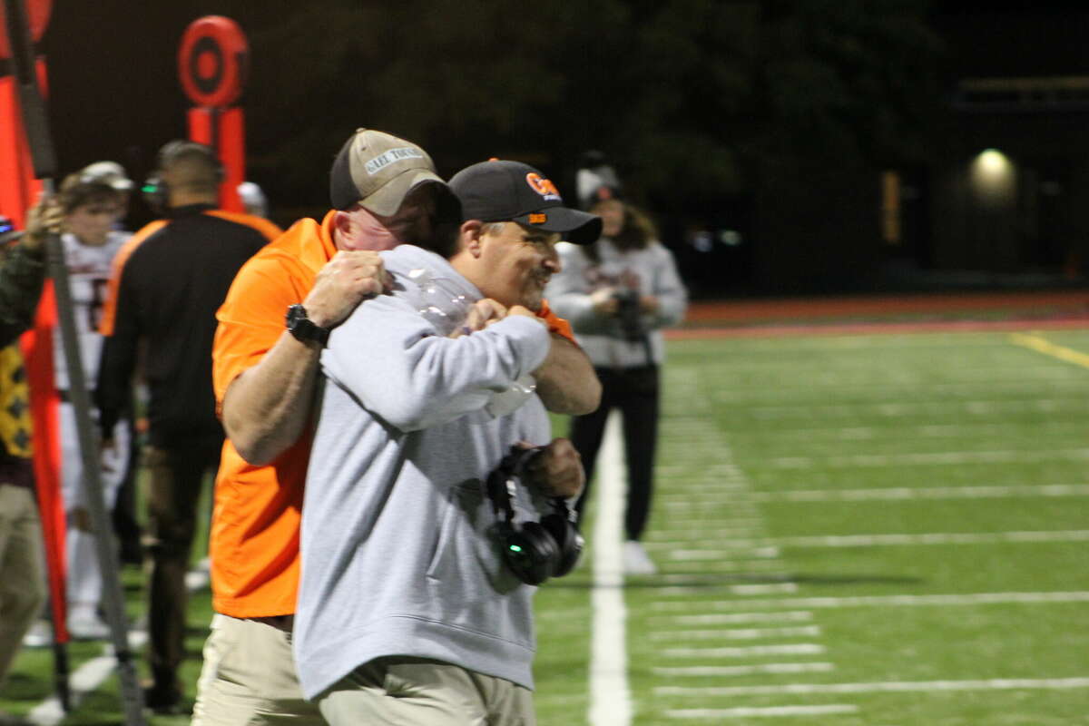 Shelton football coach Mike DeFelice is congratulated by an assistant coach after the Gaels overcame a 12-point fourth quarter deficit to defeat Windsor Friday night.