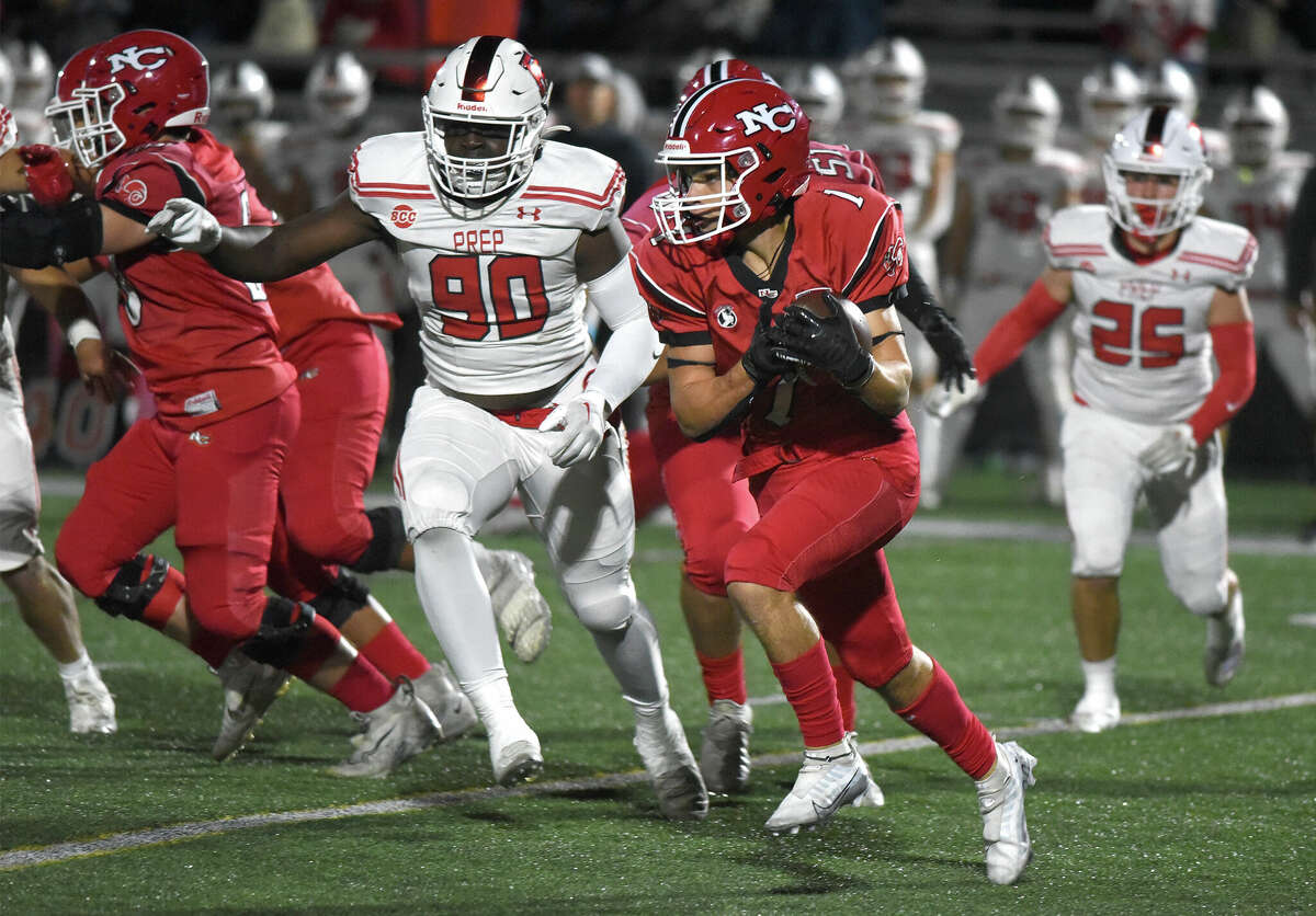 New Canaan's Hunter Telesco (1) carries the ball against Fairfield Prep during a football game at Dunning Field on Friday, Sept. 23, 2022.