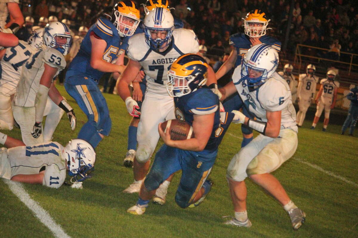 Evart's Cole Hopkins fights for yardage on Friday vs. Beal City.