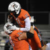 Edwardsville's Joey DeMare is congratulated by Dawson Rull after a touchdown against Belleville West on Friday inside the District 7 Sports Complex in Edwardsville.