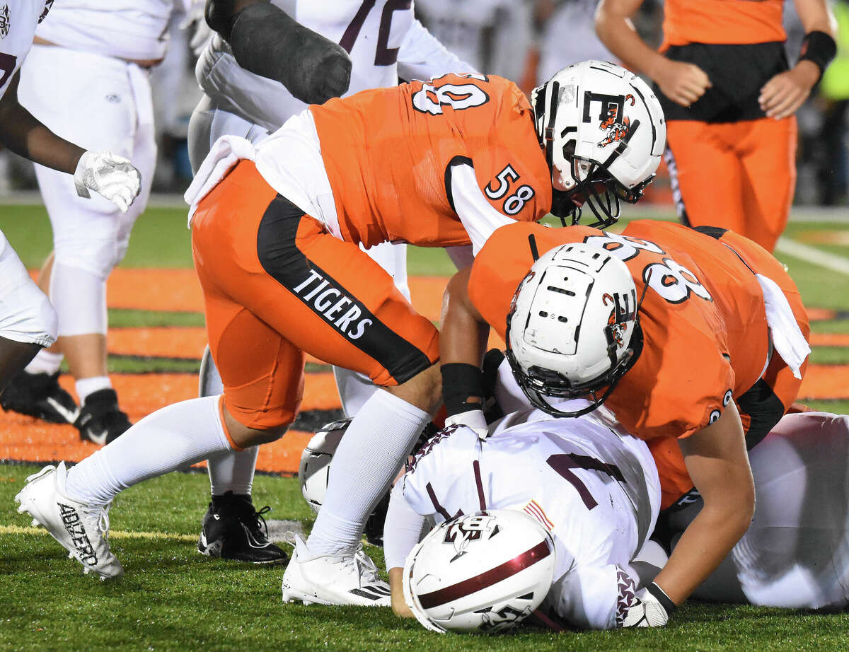 Edwardsville's Iose Epenesa with a sack with teammate Luke Williams helping against Belleville West on Friday inside the District 7 Sports Complex in Edwardsville.