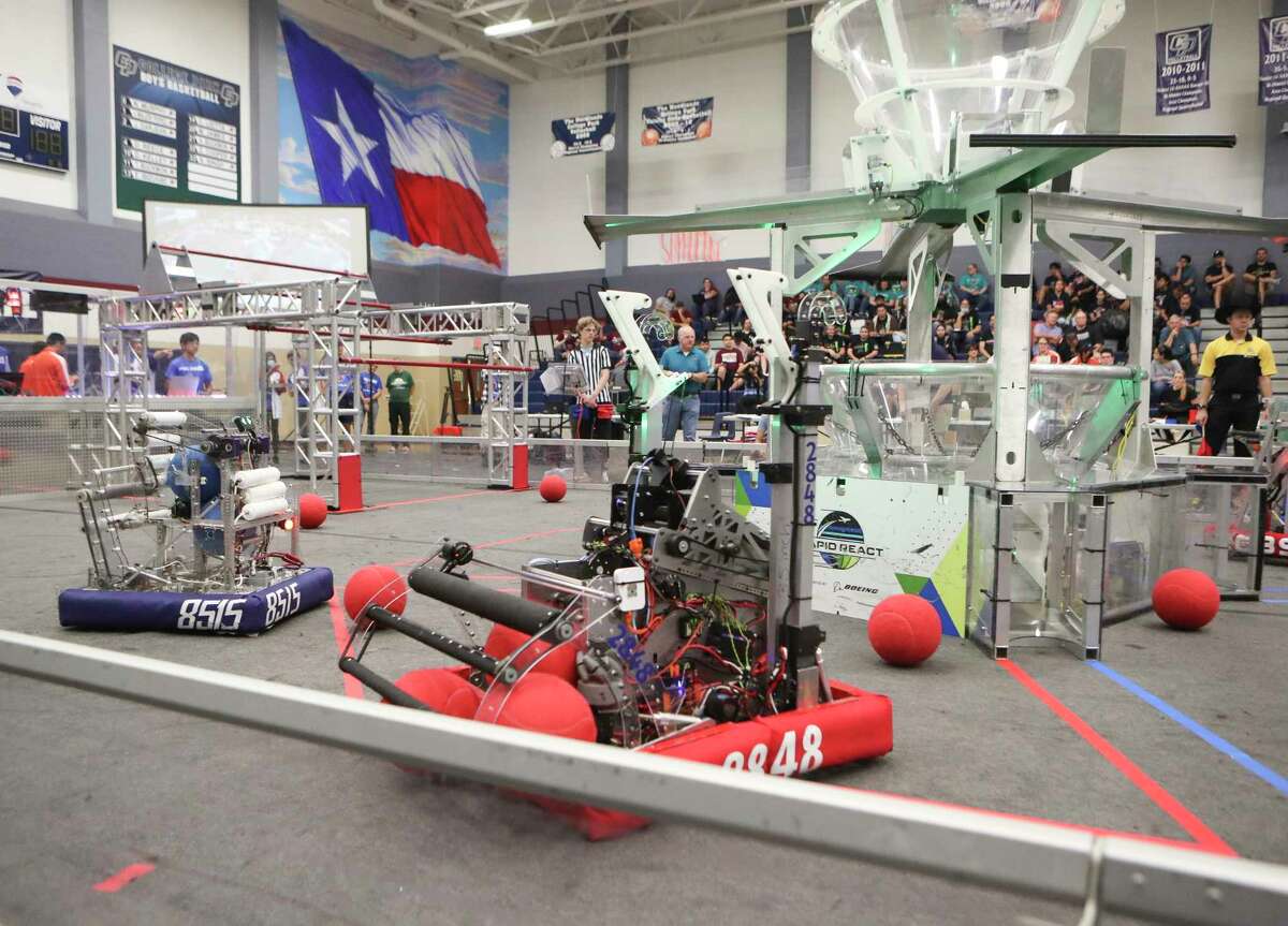 Robotic teams work to make their robots shoot balls into a container during the annual The Remix robotics competition at College Park High School, Saturday, Sept. 24, 2022, in The Woodlands. The off-season event featured 32 teams from Texas and Louisiana.