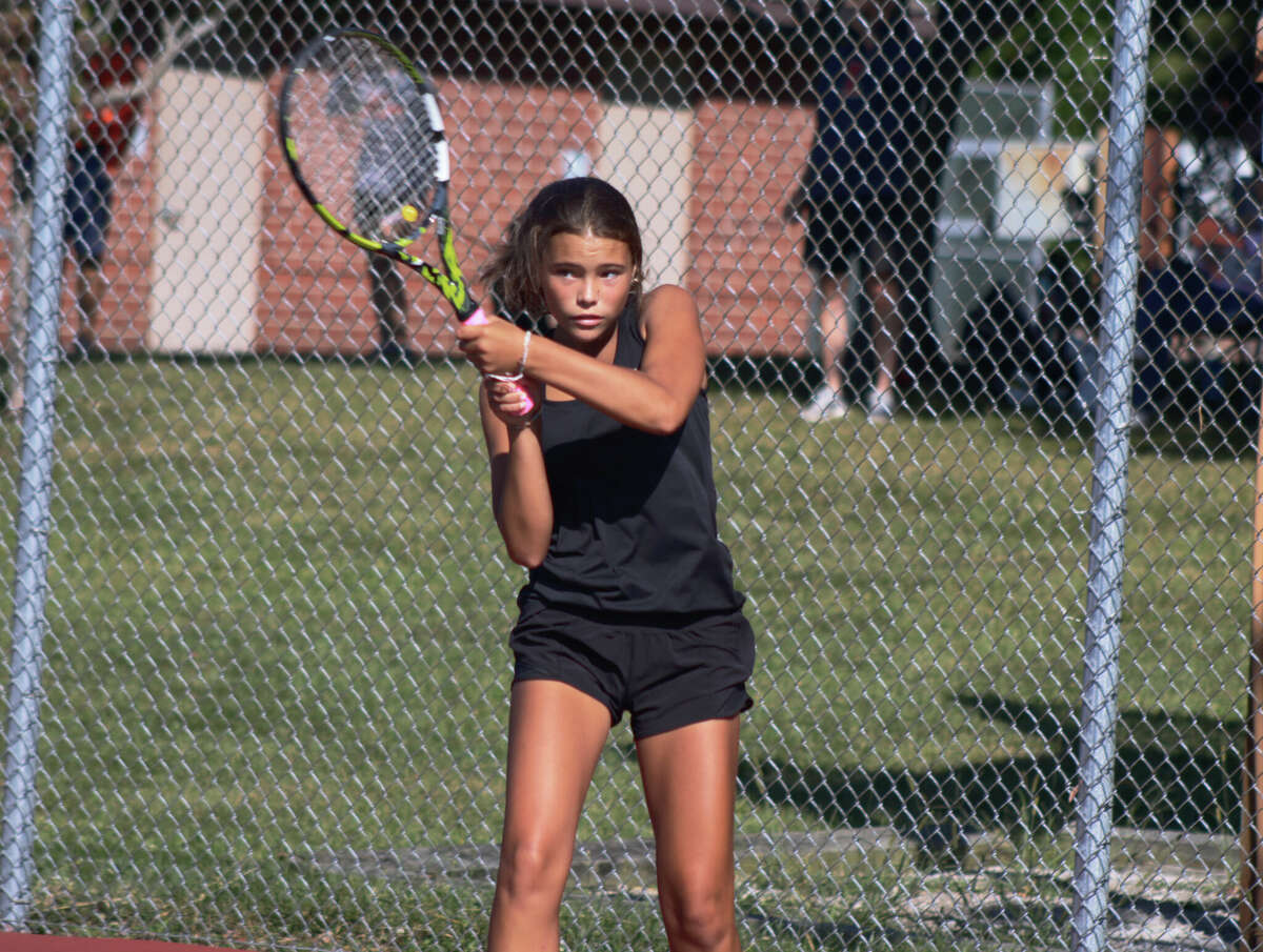 Katie Woods returns a serve against Normal Community on Saturday at the EHS Tennis Center. 