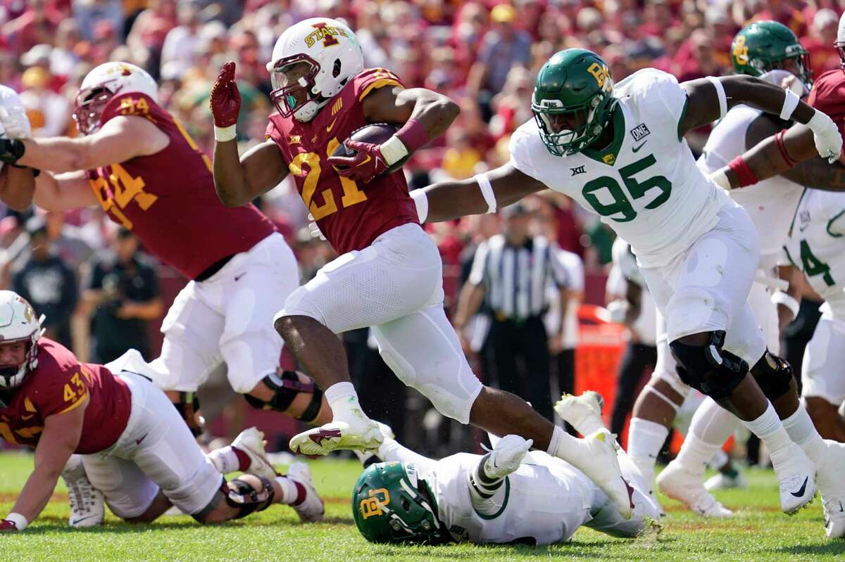 Iowa State running back Jirehl Brock (21) runs from Baylor defensive lineman Gabe Hall (95) during the second half of an NCAA college football game, Saturday, Sept. 24, 2022, in Ames, Iowa. Baylor won 31-24.