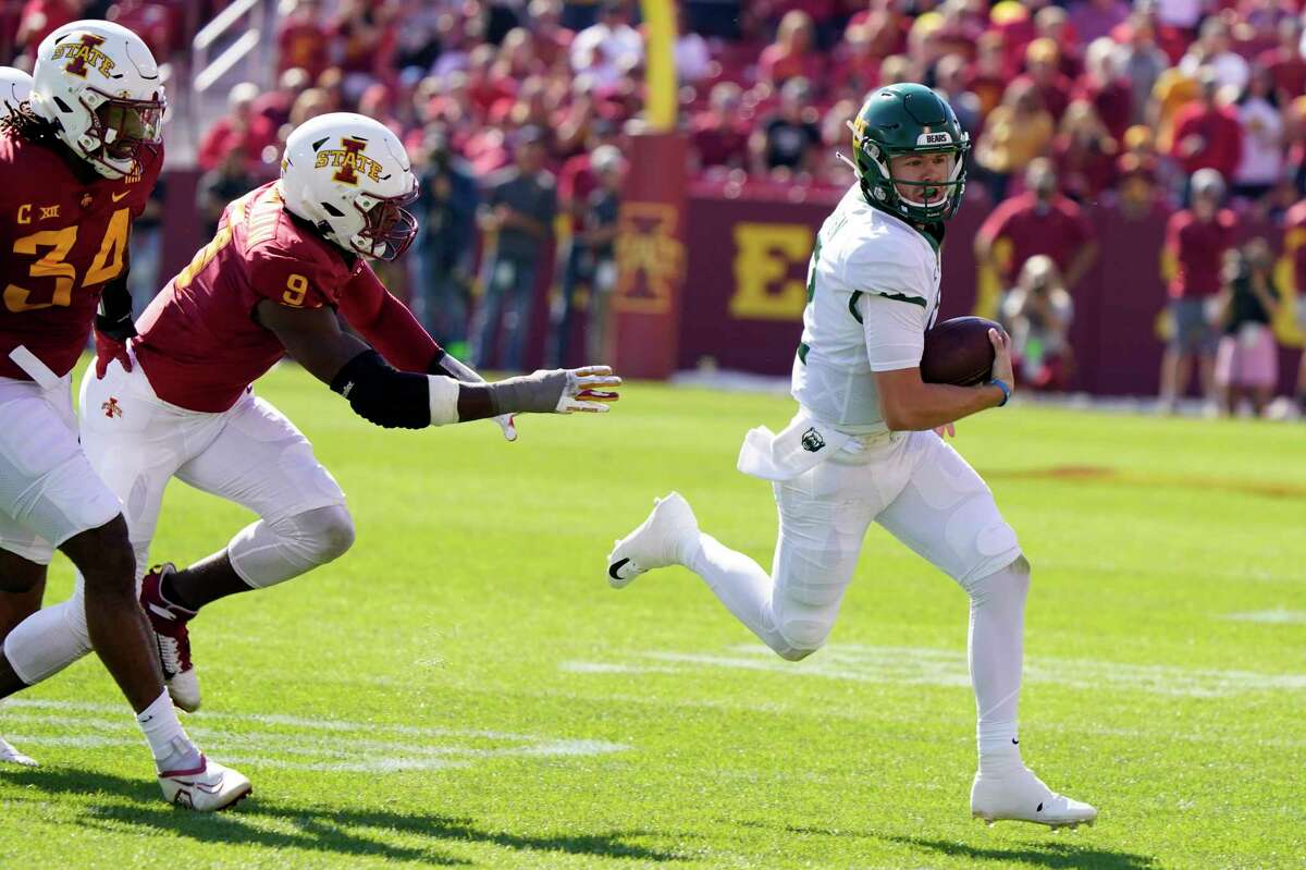 Baylor quarterback Blake Shapen, right, runs from Iowa State linebacker O'Rien Vance (34) and defensive end Will McDonald IV (9) during the first half of an NCAA college football game, Saturday, Sept. 24, 2022, in Ames, Iowa.