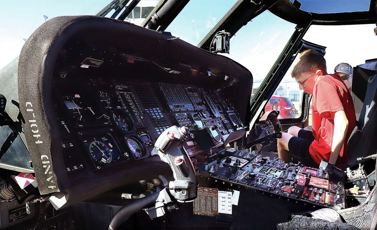 John Badman|The Telegraph Jake Hampton, 14, of Worden climbs into the cockpit of a Blackhawk helicopter while visiting the Fly-In with his father, Jason.