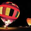 John Badman|The Telegraph Two hot air balloons light up the night at the edge of the tarmac Friday night at the St. Louis Regional Airport in Bethalto.