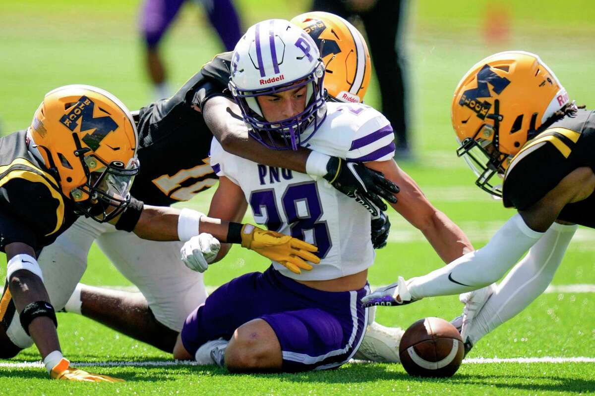 Marshall specialist Trent Thomas, right, recovers the fumble of Port Neches-Groves kick returner Reid Richard, center, during the first half of a high school football game, Saturday, Sept. 24, 2022, in Sugar Land, TX.